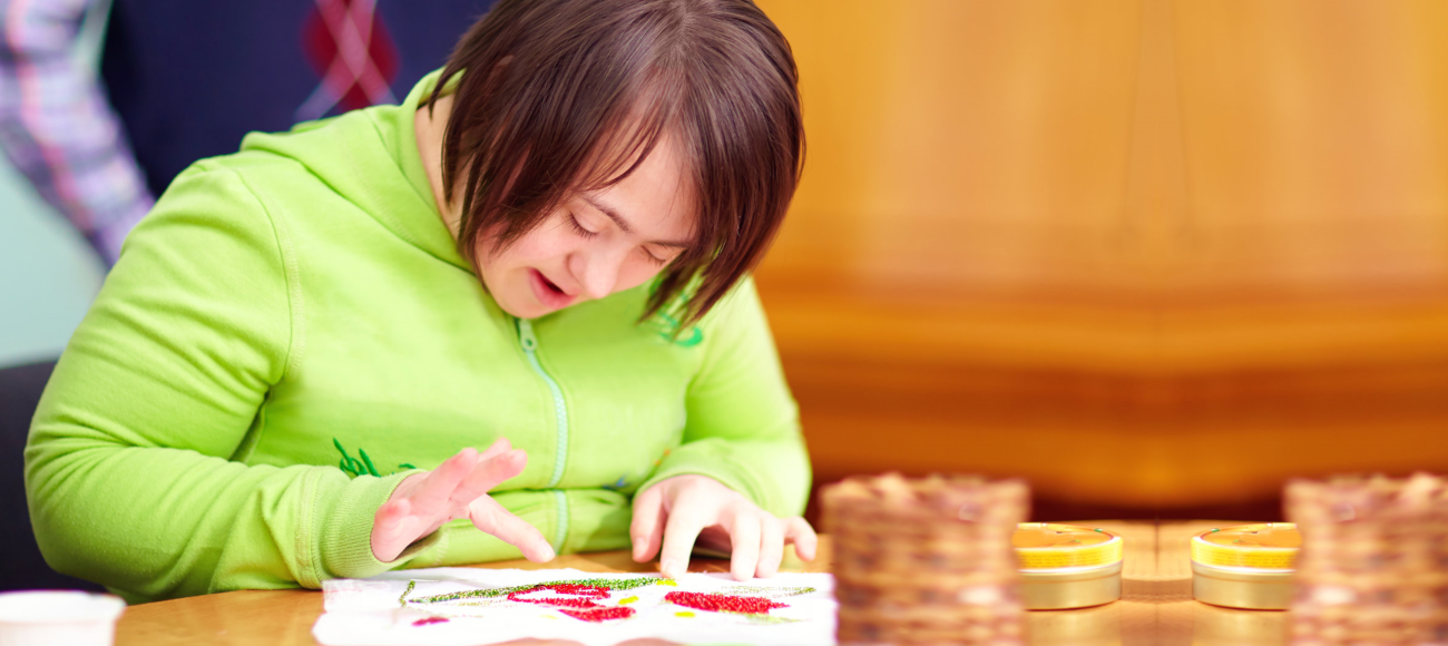 Young adult woman with disability doing art