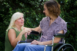 woman taking care of an elderly in a wheelchair